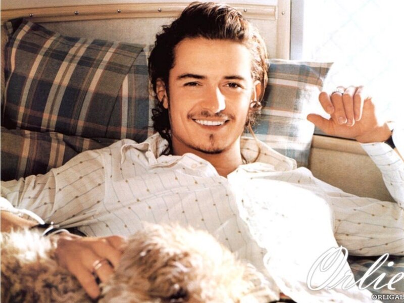 man with dog on bed