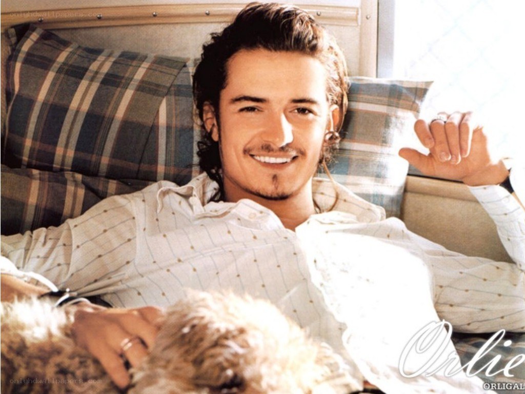 man with dog on bed