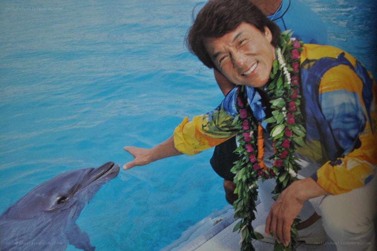 man with dolphin at pool