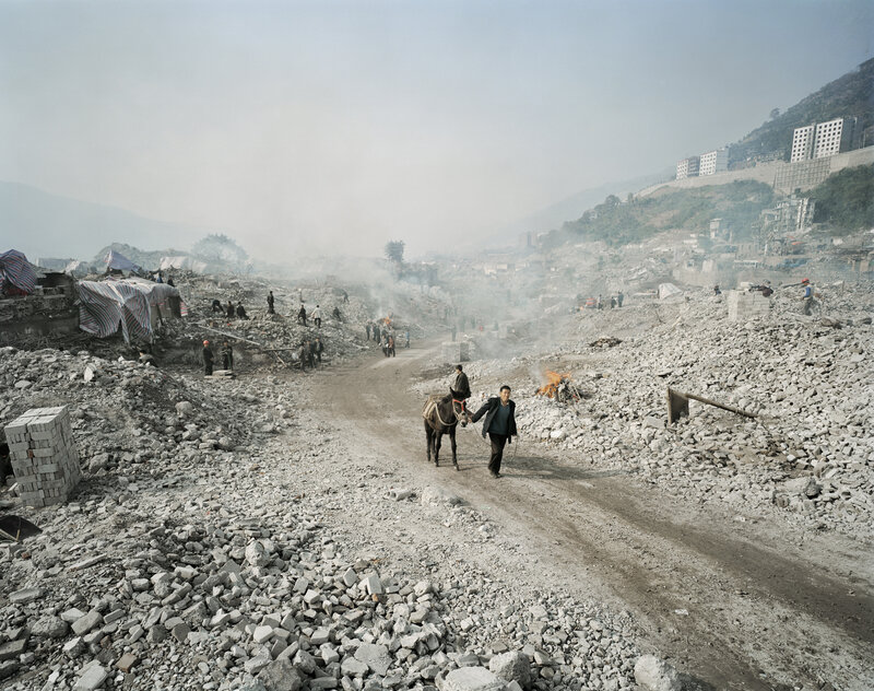 Man with donkey in rubble