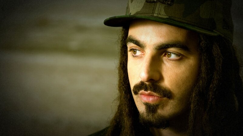 man with dreadlocks and cap
