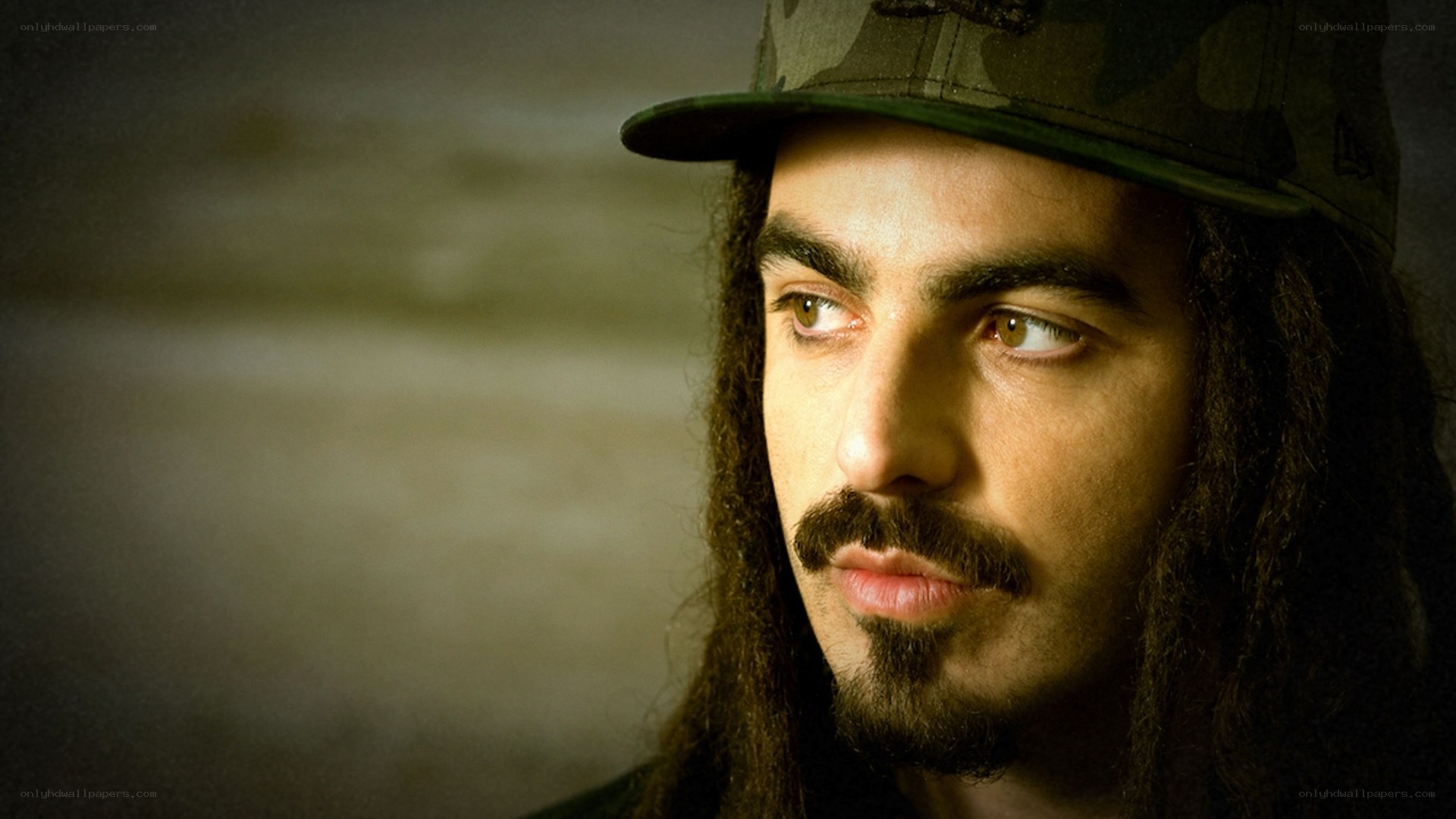 man with dreadlocks and cap
