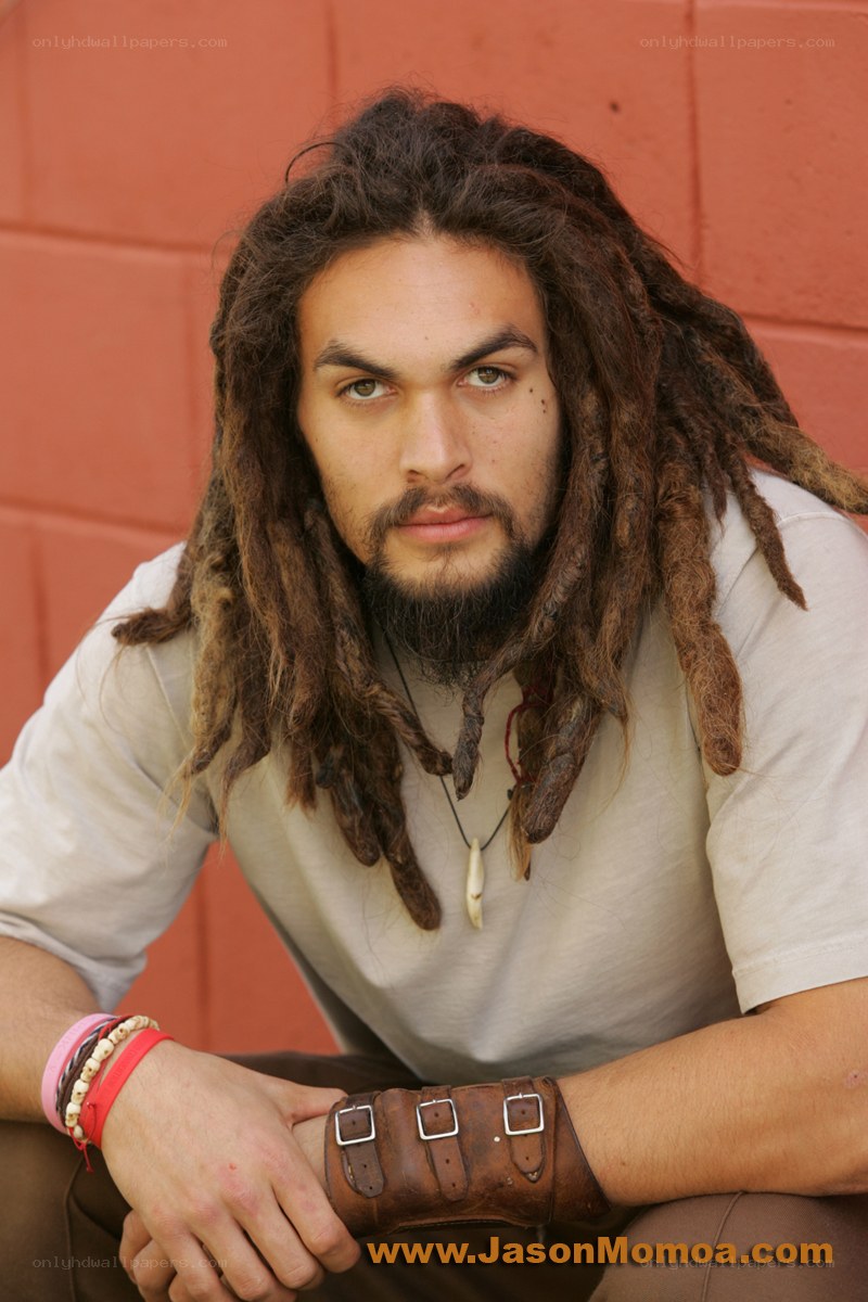 man with dreadlocks and leather bracer