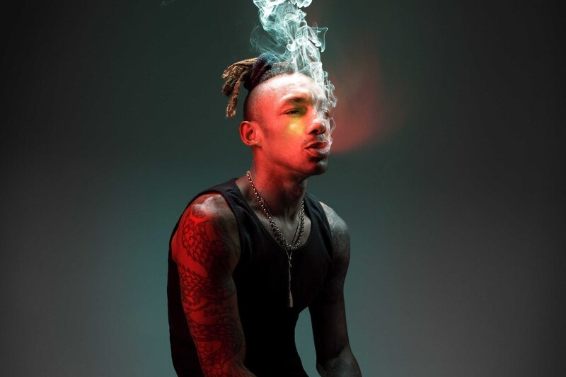 man with dreadlocks and smoke