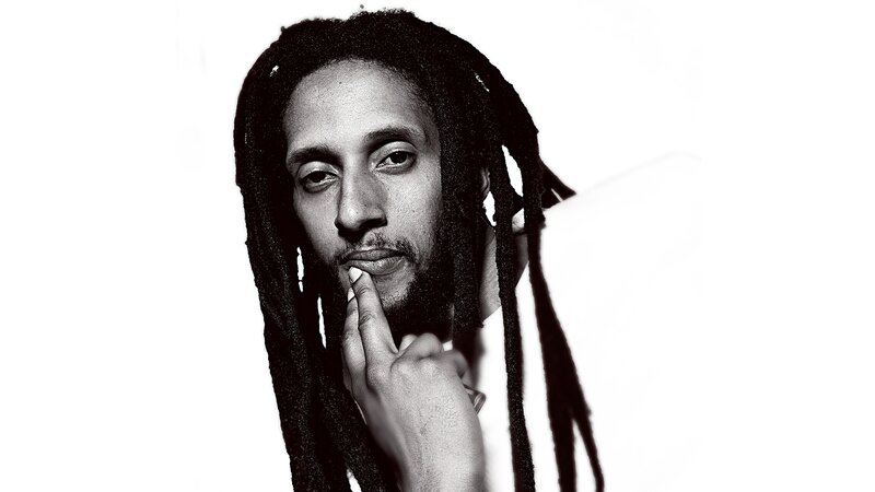man with dreadlocks in black and white