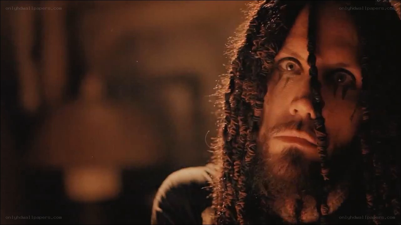man with dreadlocks in dim light