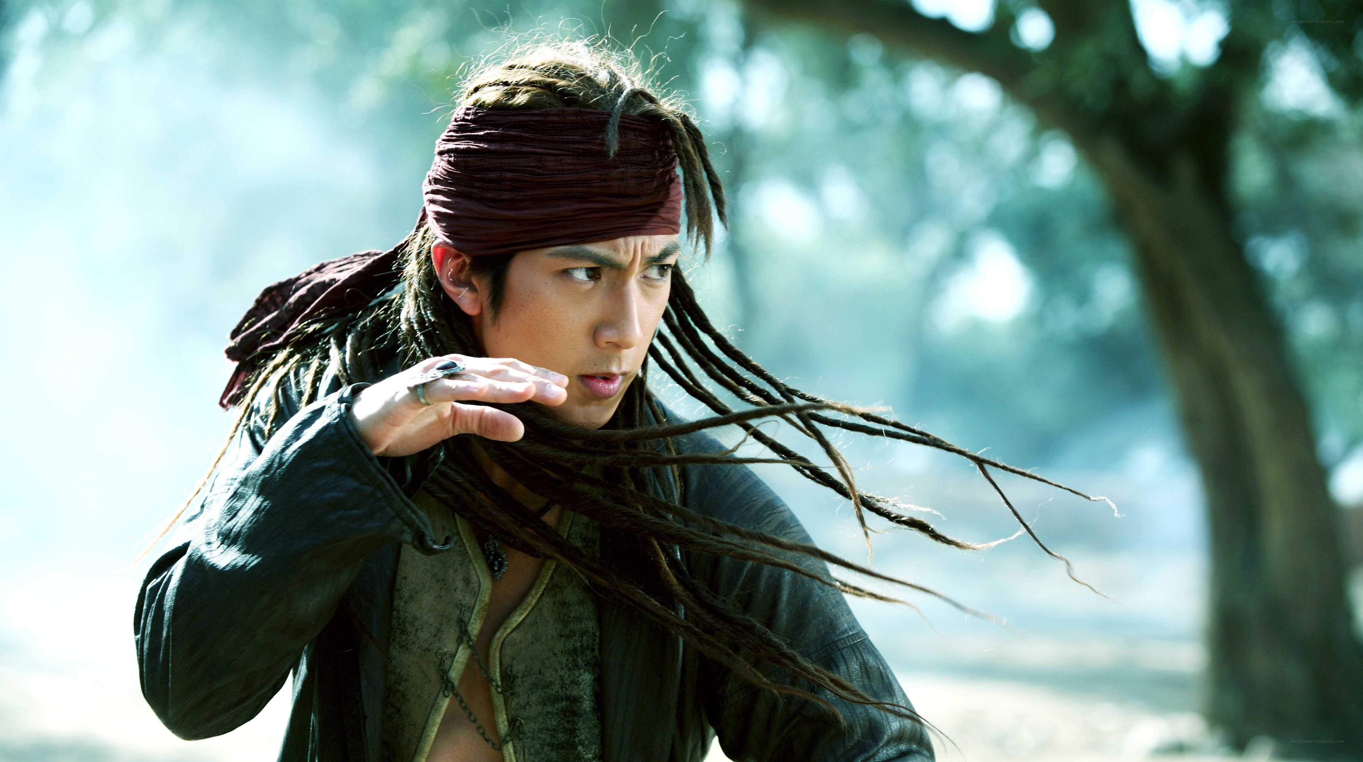 man with dreadlocks in forest
