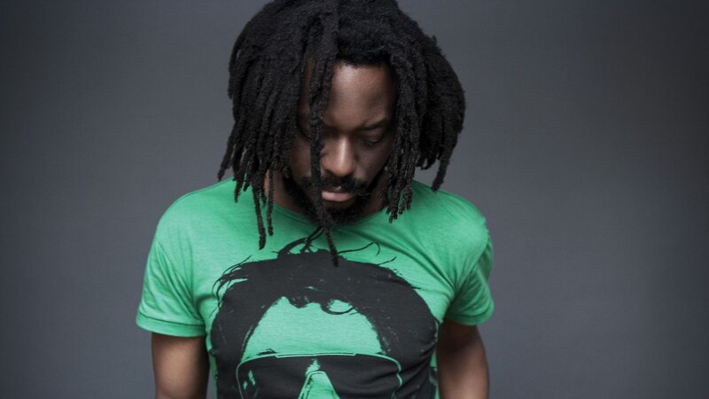 man with dreadlocks looking down