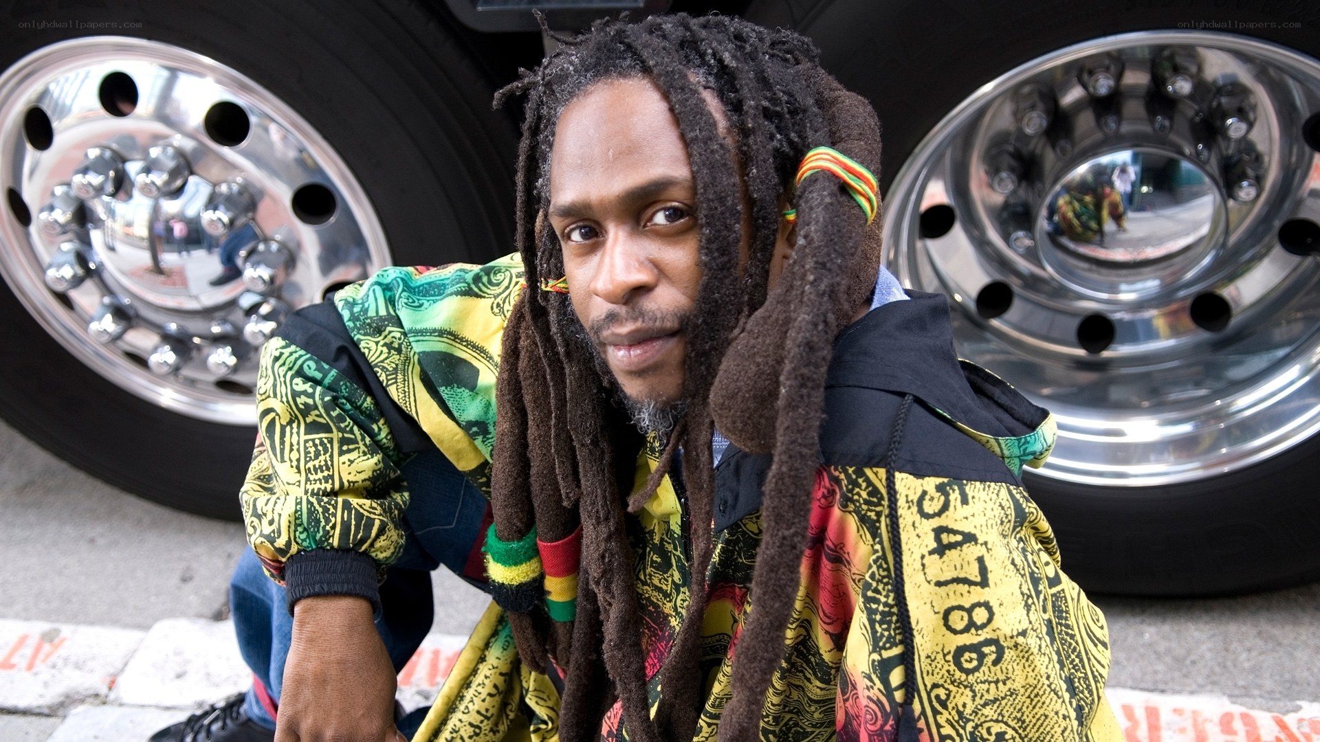 man with dreadlocks near truck
