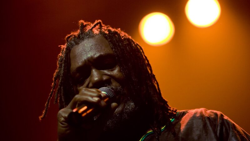 Man with Dreadlocks Singing — Red