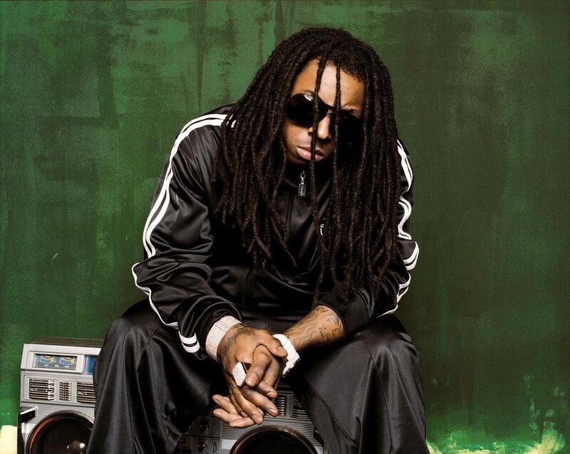 man with dreadlocks sitting on boombox