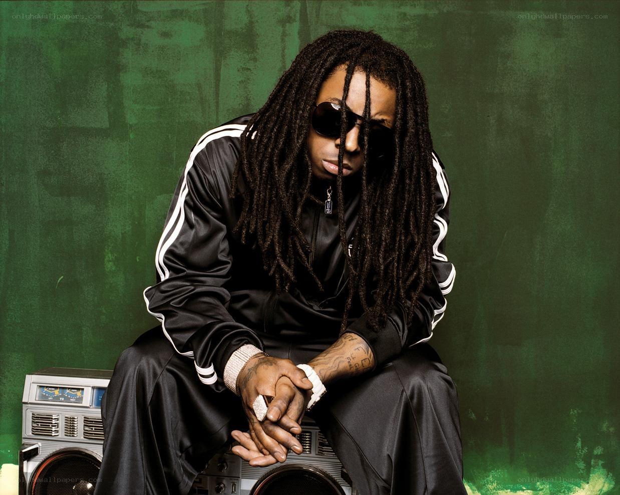 man with dreadlocks sitting on boombox