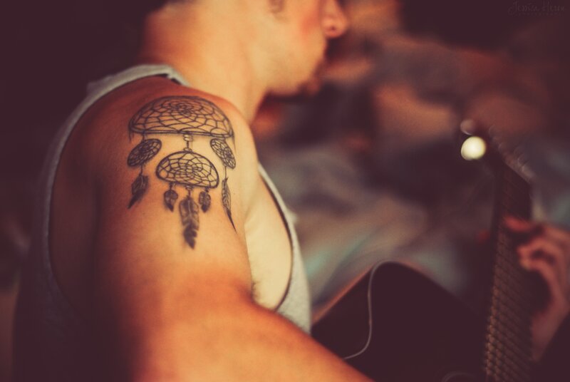 man with dreamcatcher tattoo
