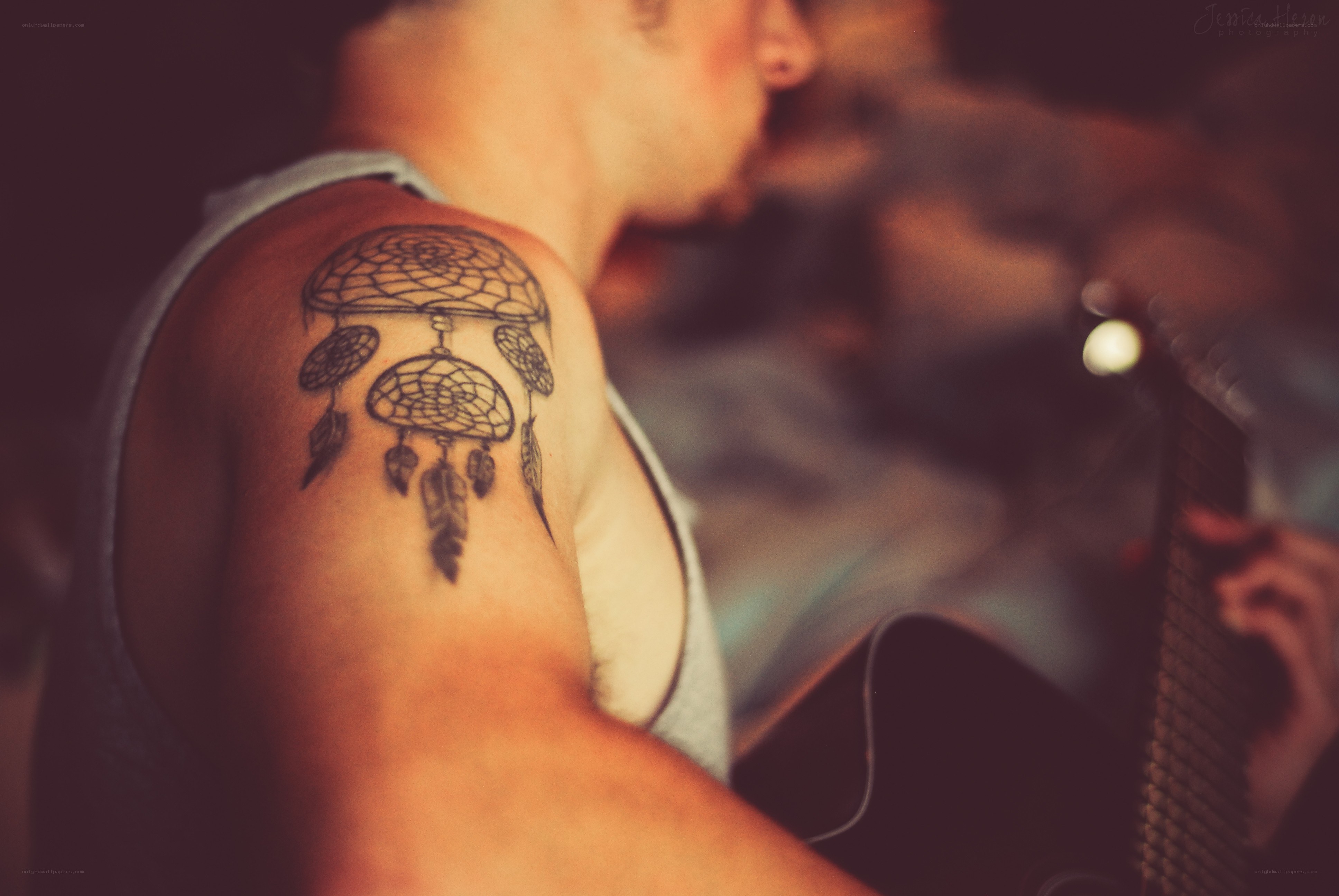 man with dreamcatcher tattoo