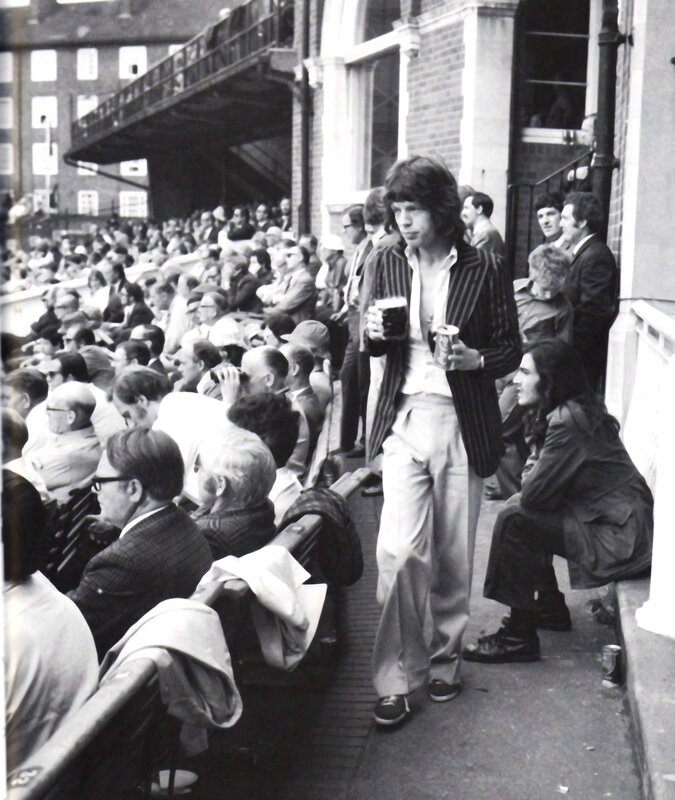Man with drinks in crowd