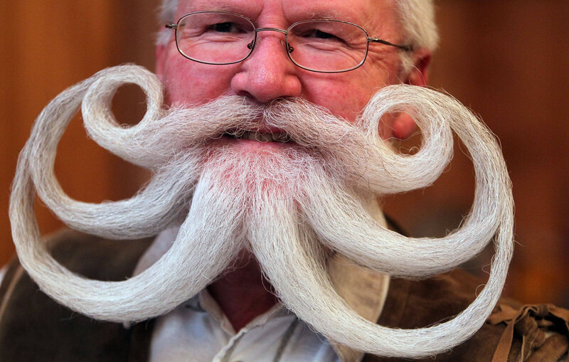 man with elaborate curled mustache