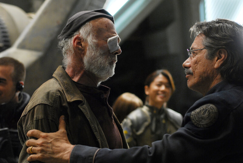 man with eye patch in conversation