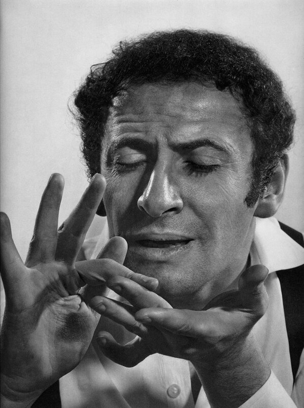 man with eyes closed gesturing