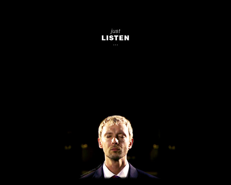 man with eyes closed listening