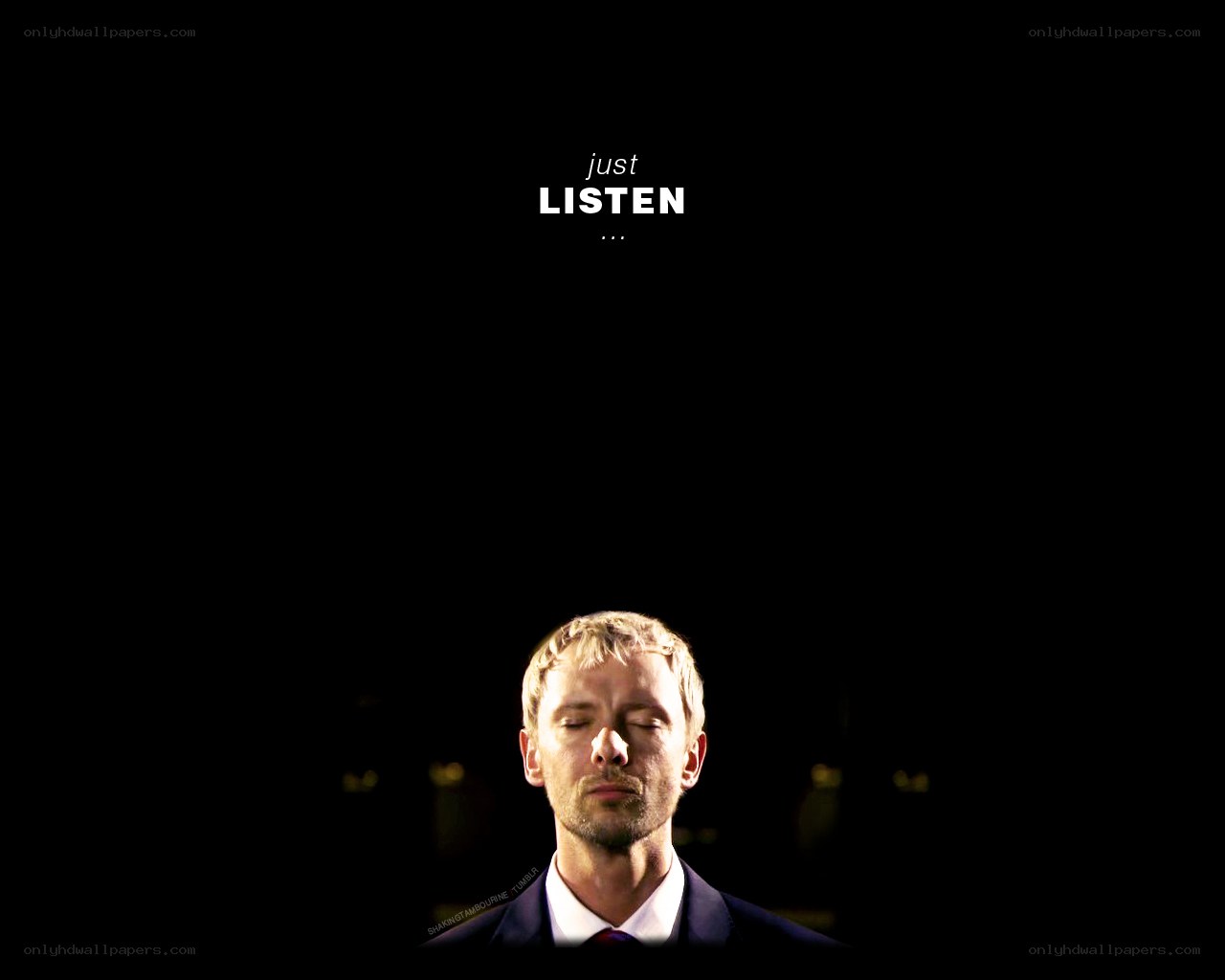 man with eyes closed listening