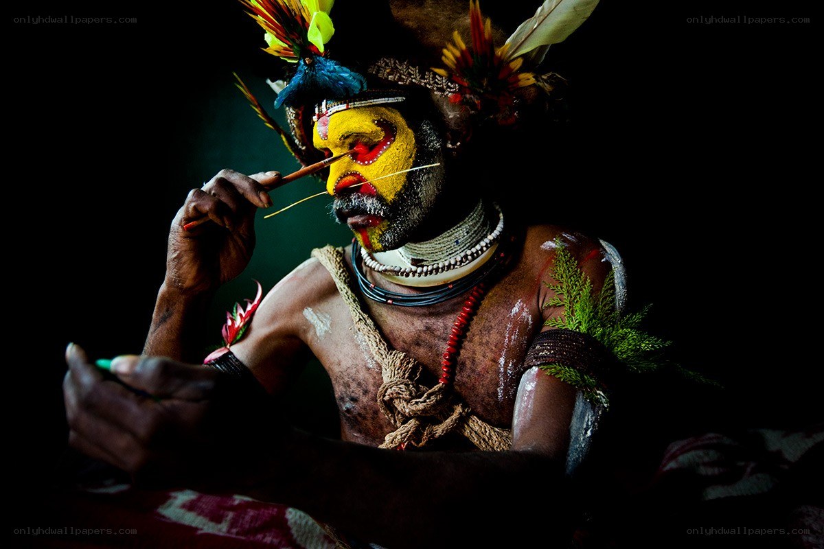 Man with face paint applying makeup