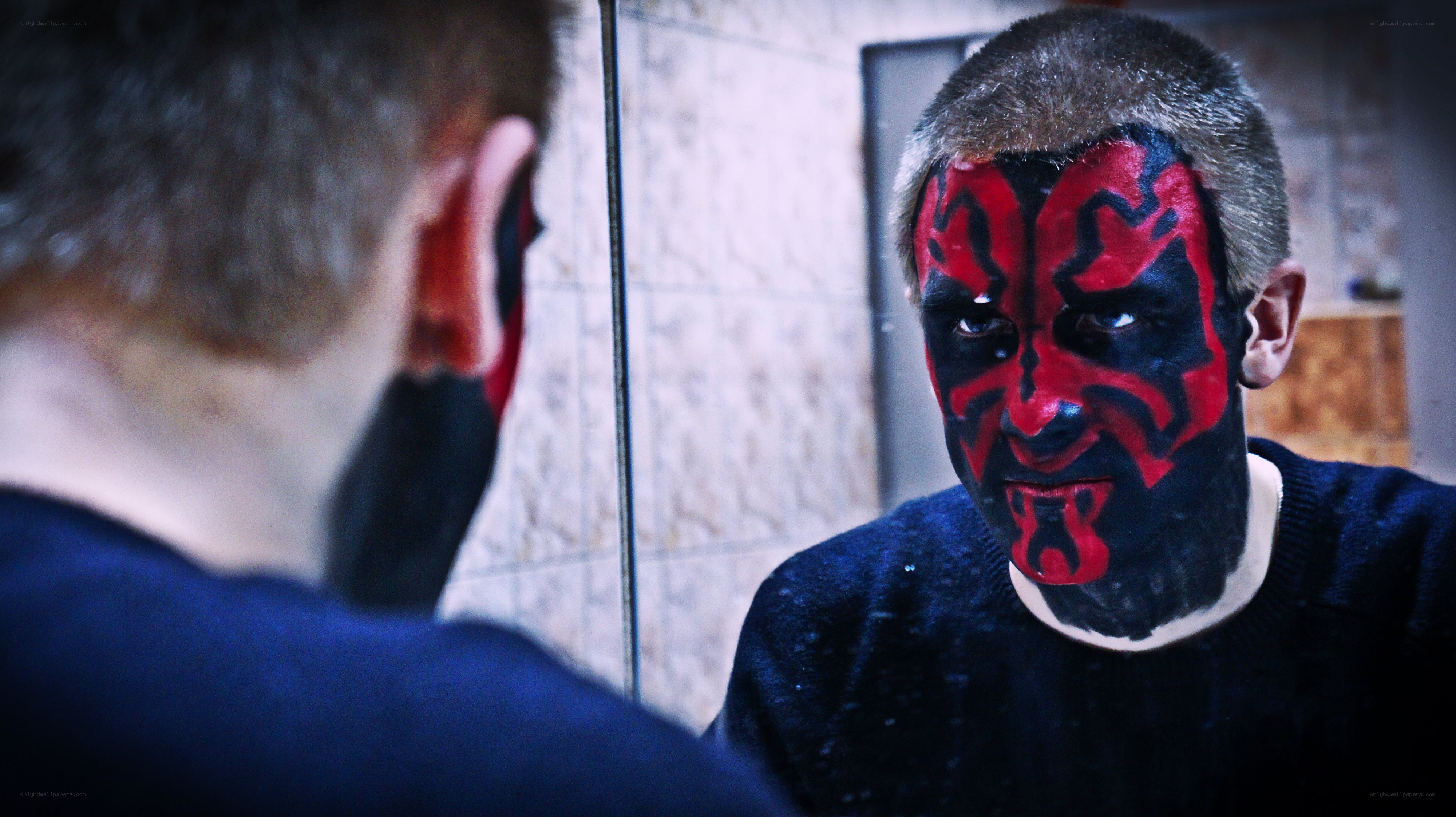 man with face paint in mirror