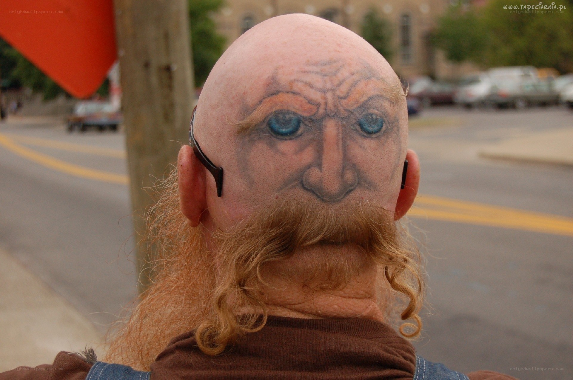 Man with face tattoo on head