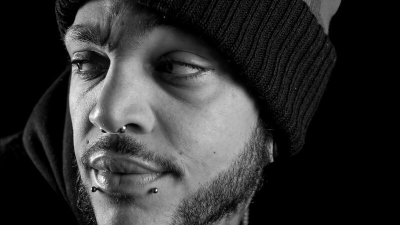 Man with Facial Piercings — Black