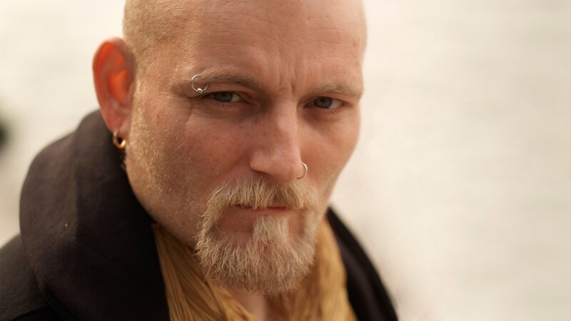 man with facial piercings