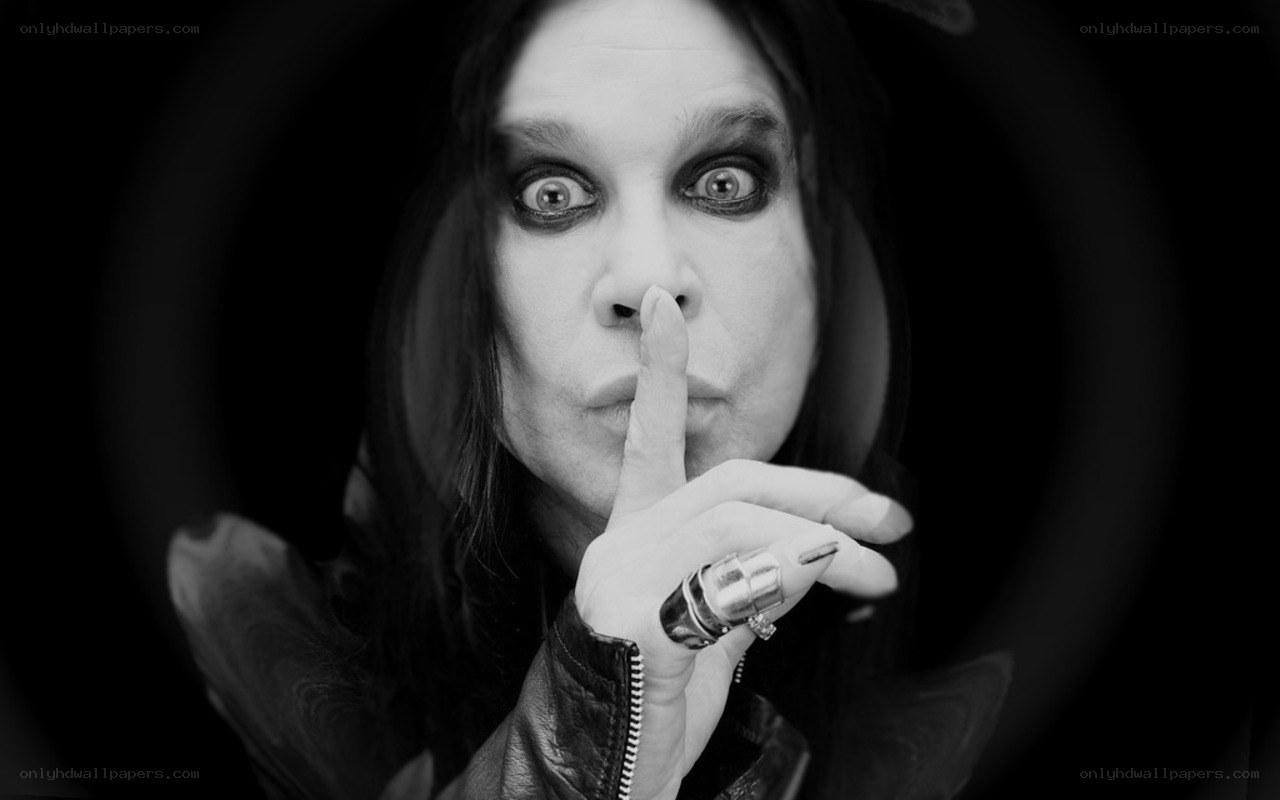 man with finger to lips