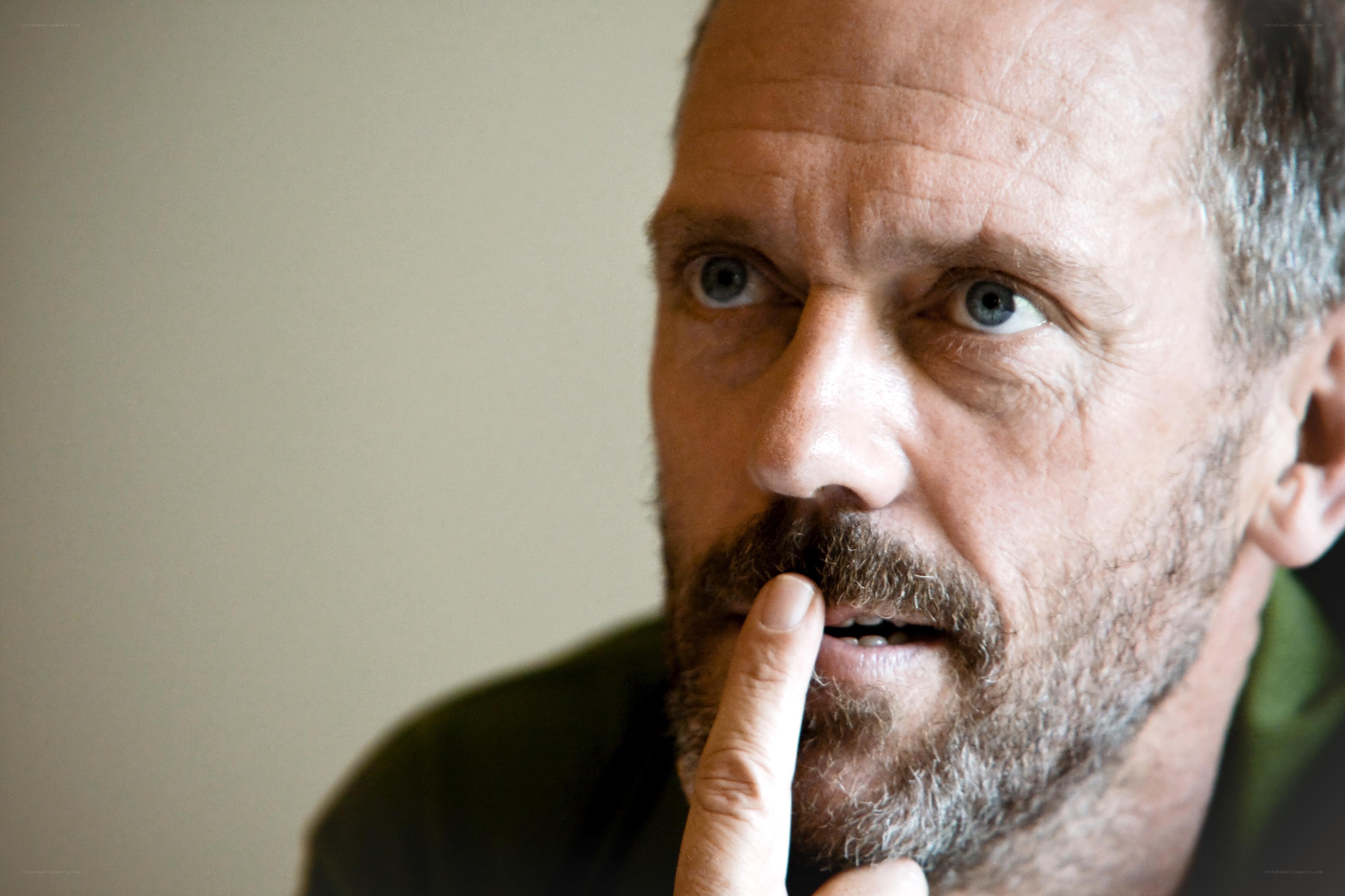 man with finger to mouth
