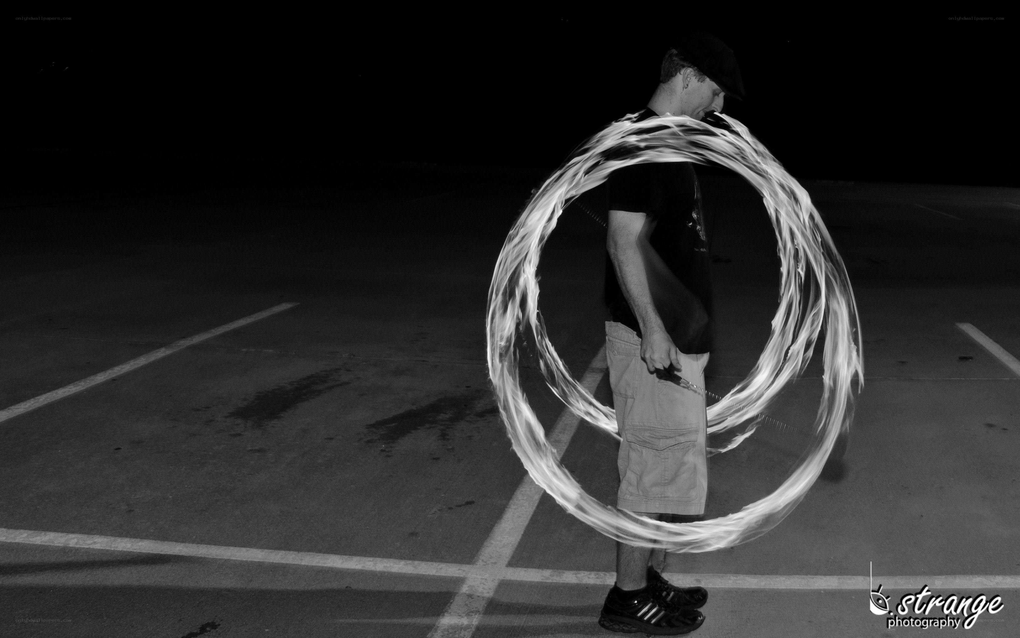 man with fire hoop at night