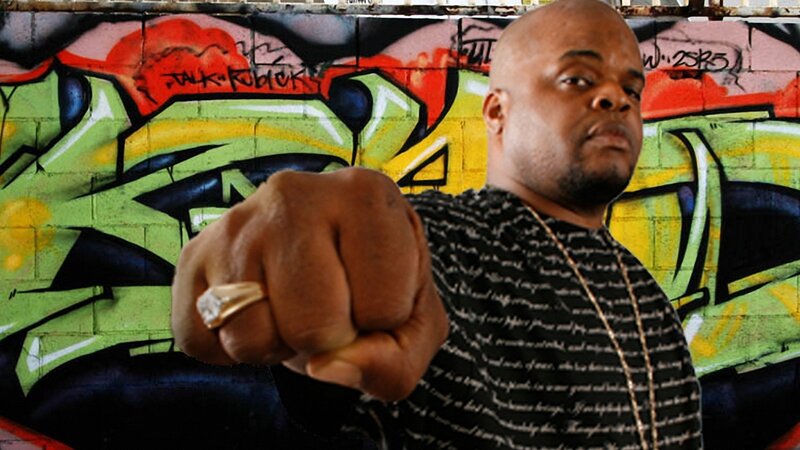 man with fist in front of graffiti