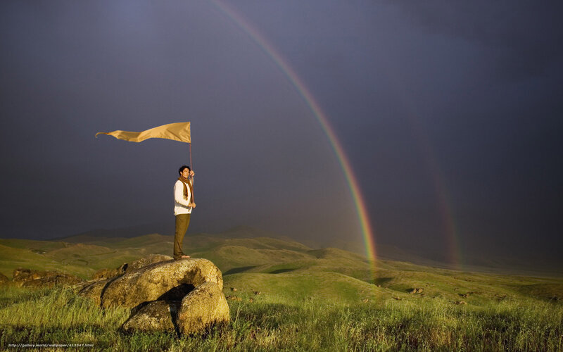Man with flag on hill