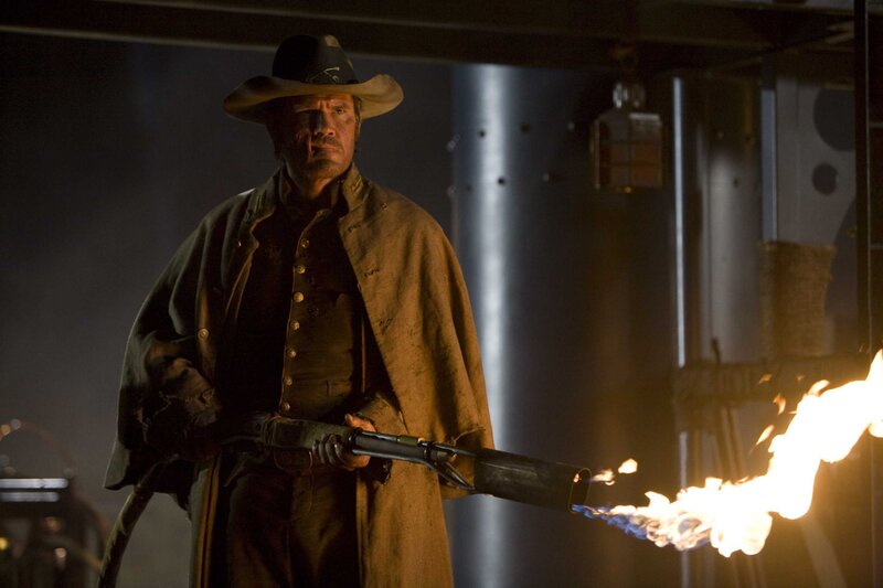 Man with flamethrower in dim room