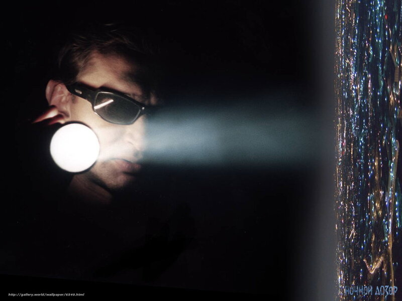 Man with flashlight at night