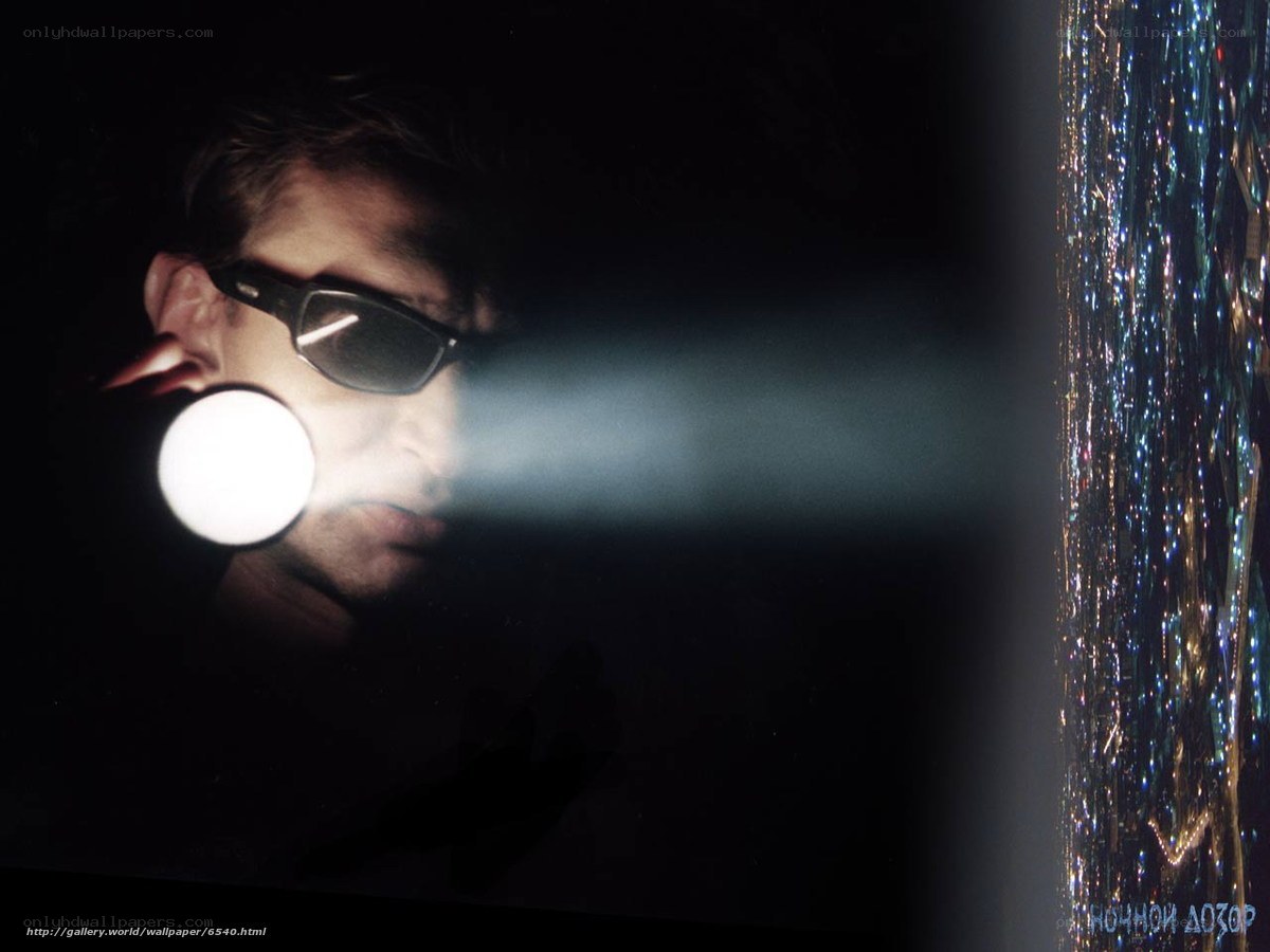Man with flashlight at night