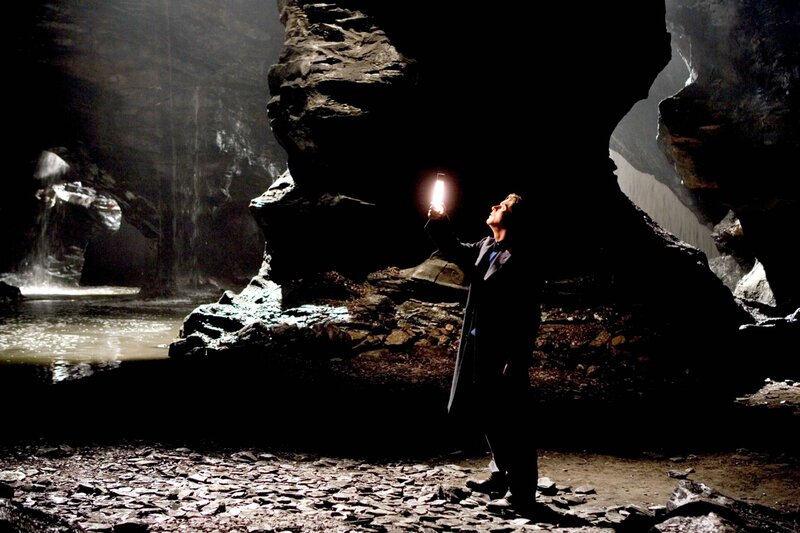 Man with Flashlight in Cave