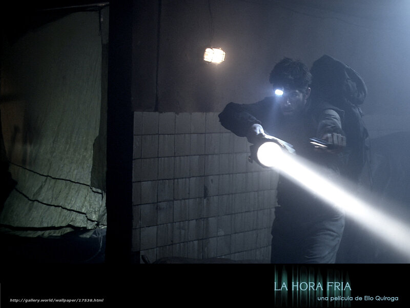 man with flashlight in dark room