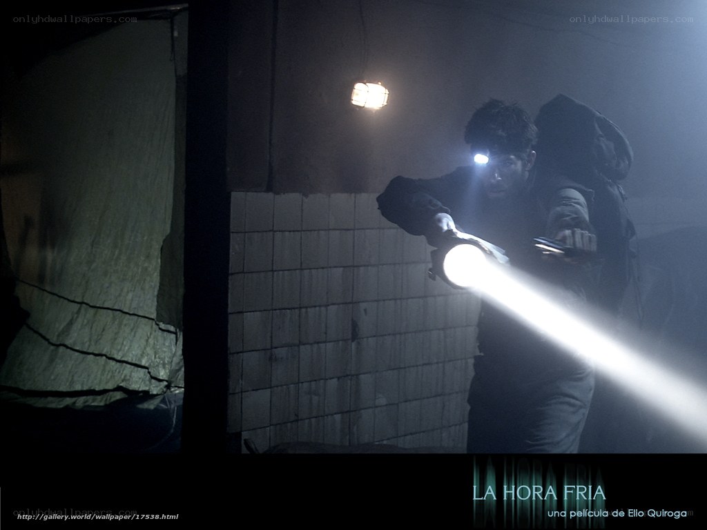 man with flashlight in dark room