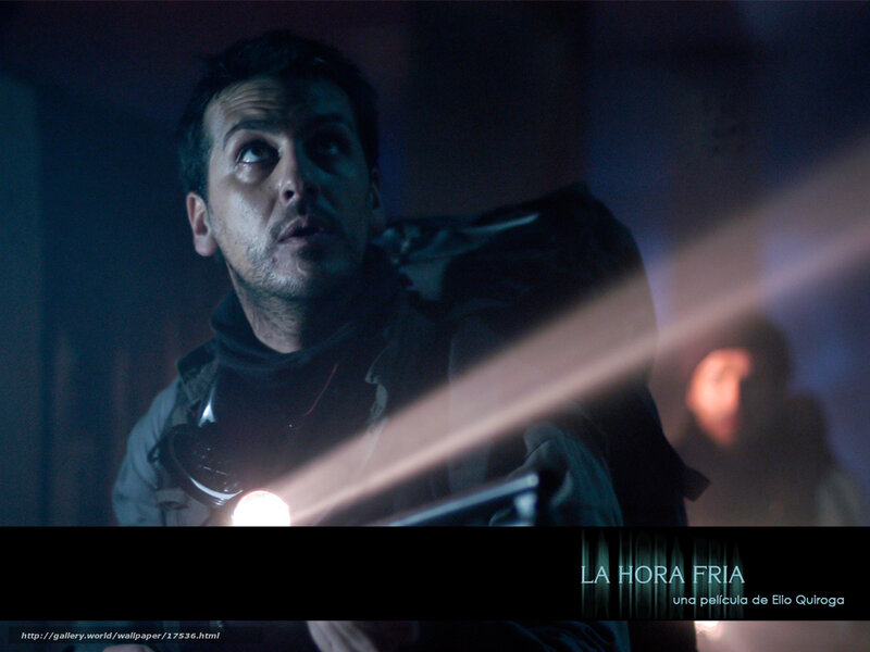 man with flashlight in dark room
