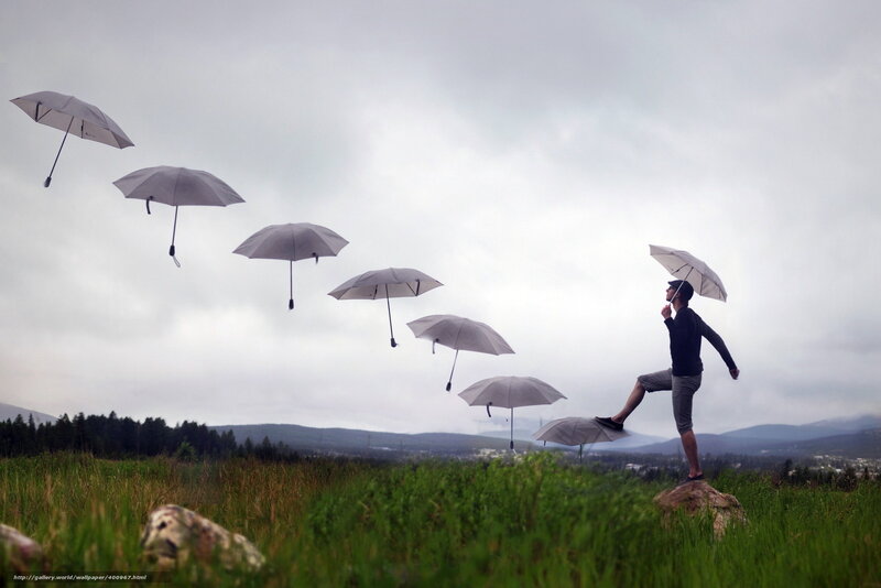 Man with floating umbrellas