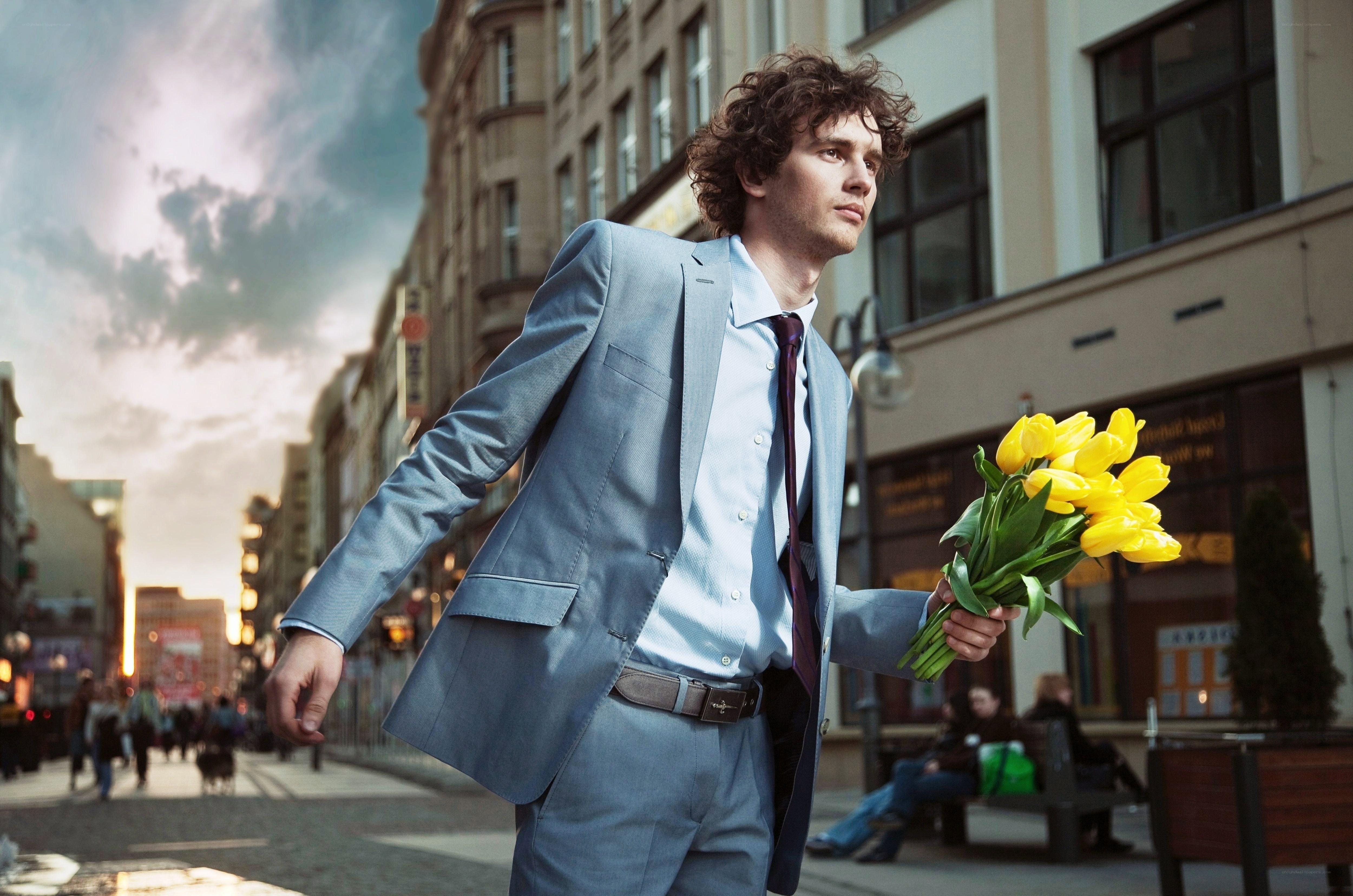 Man with flowers in city