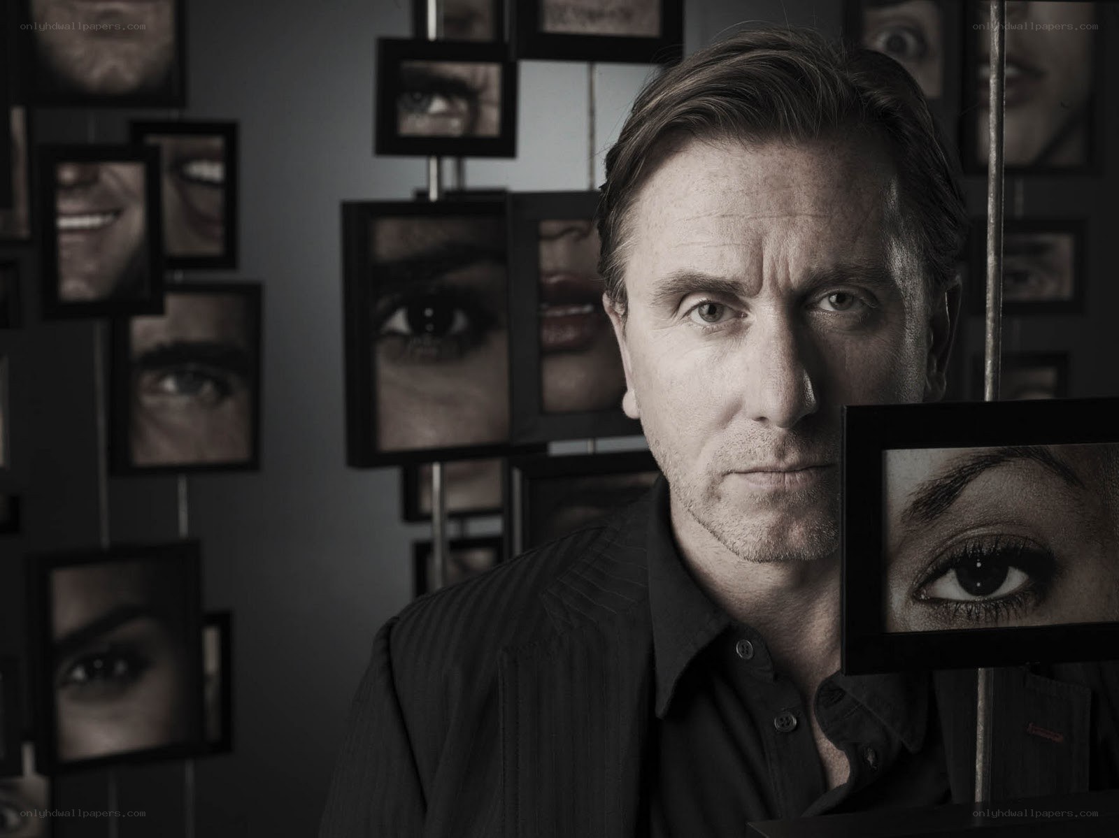 man with framed eyes in background