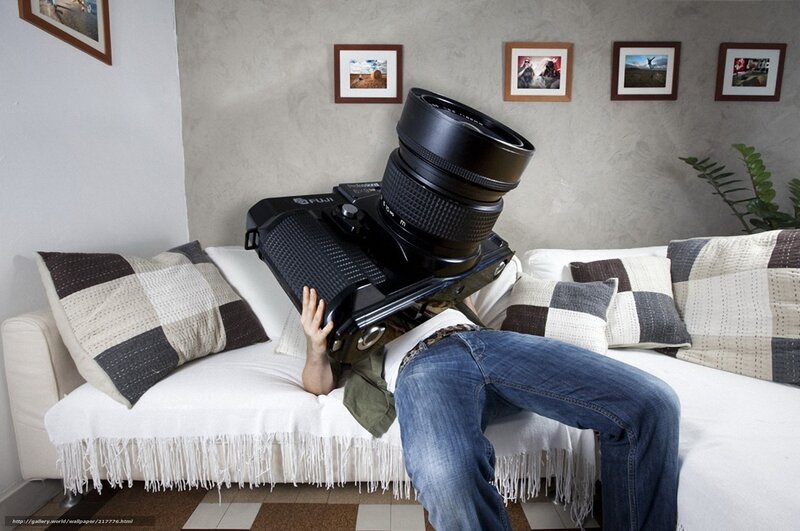 Man with giant camera on couch