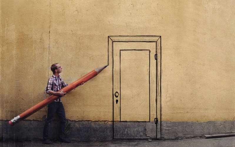 Man with giant pencil drawing door