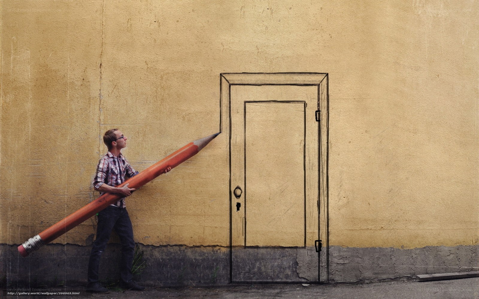 man with giant pencil drawing door