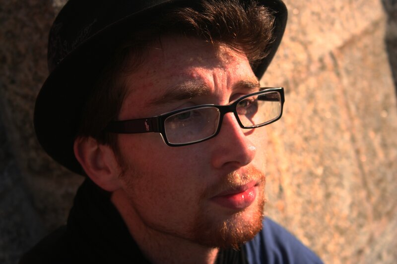 man with glasses and hat