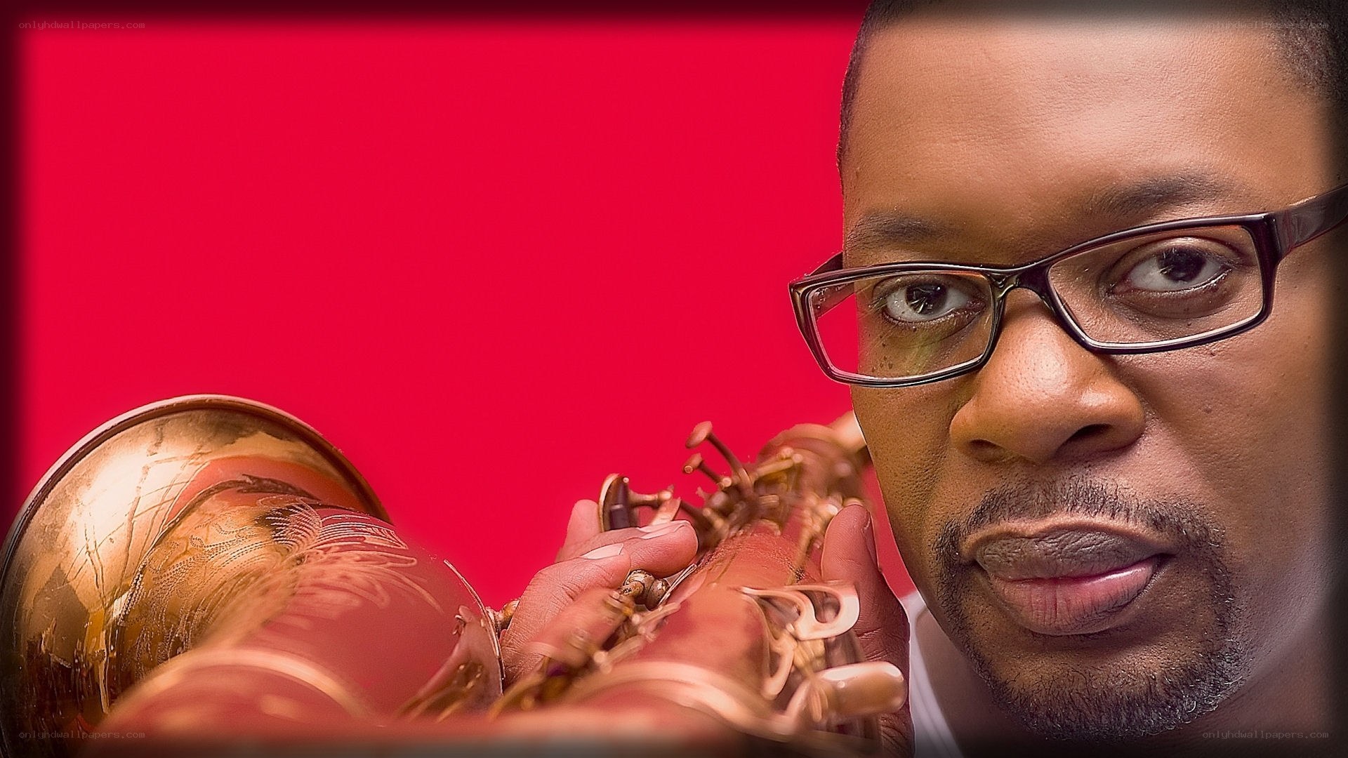 man with glasses holding trumpet