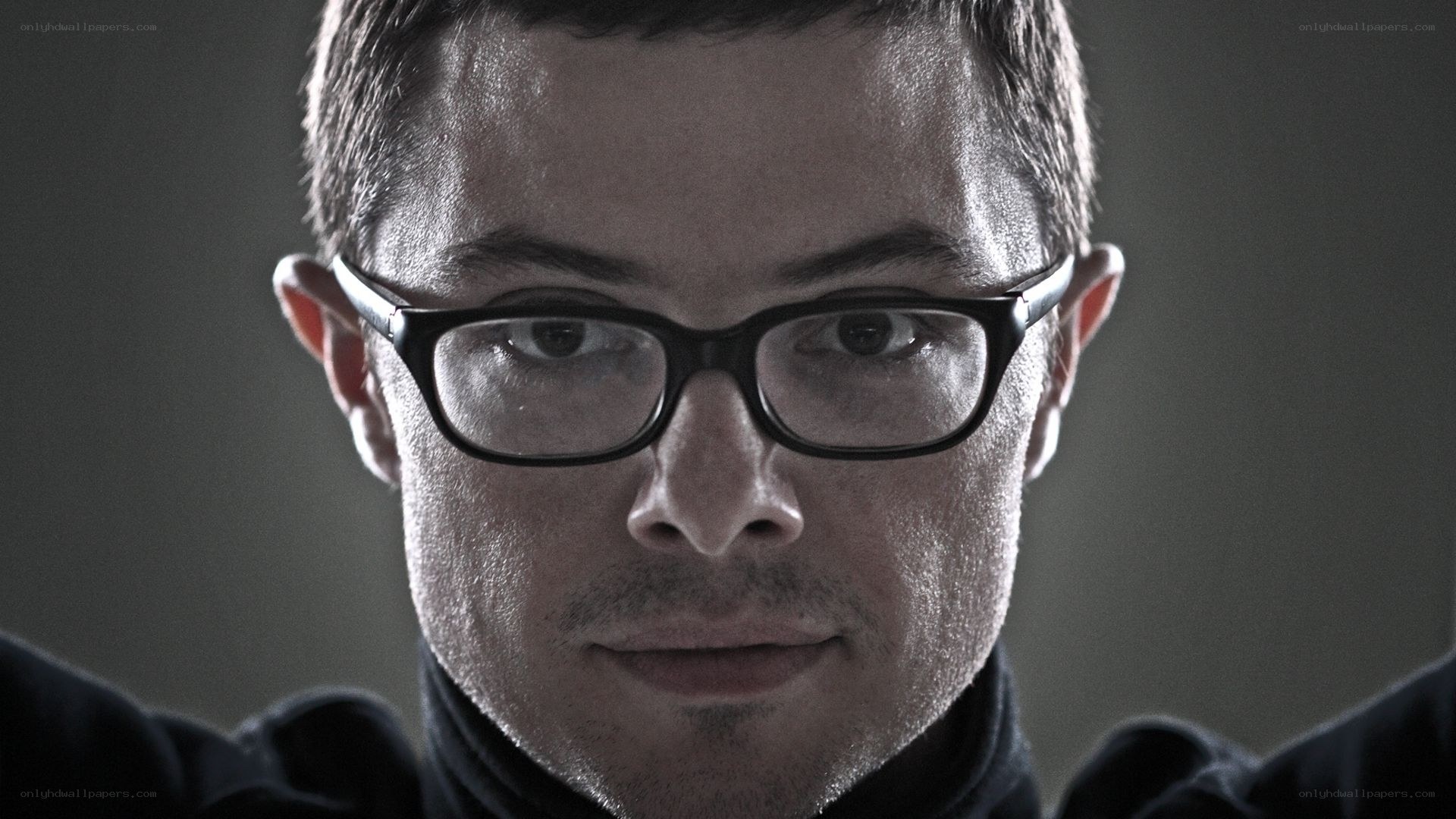 man with glasses looking at camera
